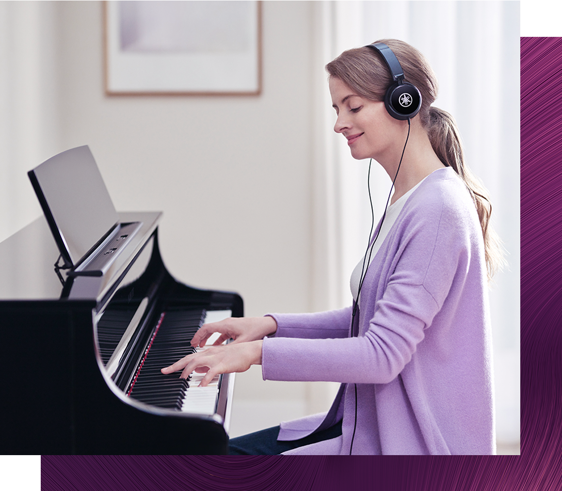 woman playing piano with headphones to inspire gift ideas for piano players